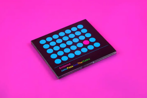 A crushed can of Coca-Cola against a red background